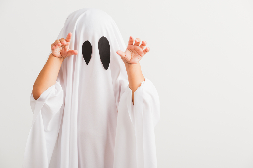 Child in ghost Halloween costume.